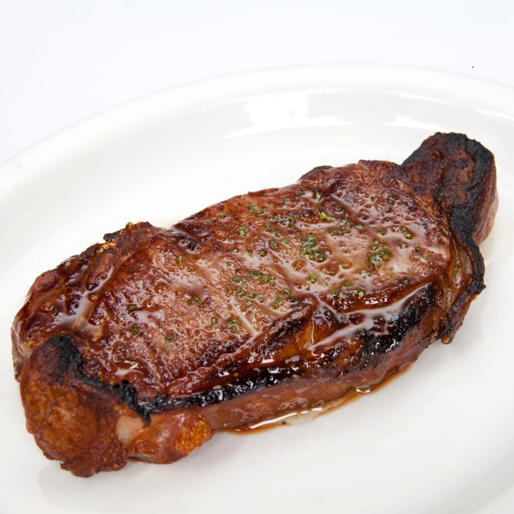 Resting a juicy New York strip steak on a plate